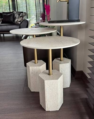 Three side tables with round stone tops, brass stems and hexagonal travertine bases.